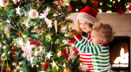 Children Decorate The Christmas Tree Photo